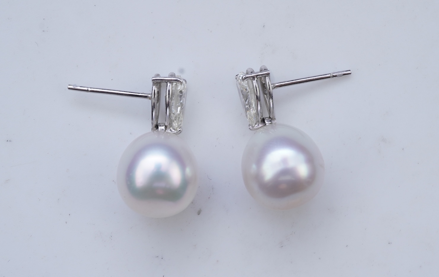 A pair of cultured pearl and diamond earrings